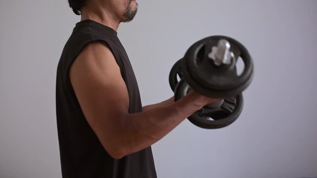 Man working biceps curl with supinated position with dumbbell.