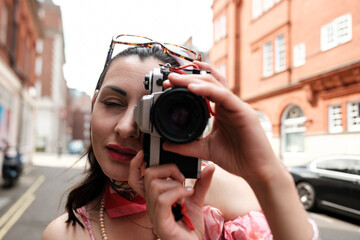 Tourist taking photos in london with analog camera