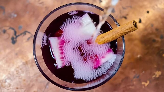 Traditional, Chicha Morada with a cinnamon stick and fruit slices, Warm indoor lighting, Sweet and spicy tones, Inviting and refreshing
