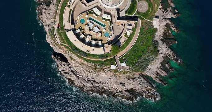 Aerial top shot above Mamula Island revealing circular fortress layout and natural coastline below