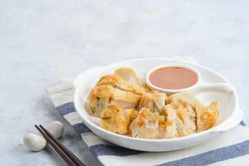 Batagor, made from fish or chicken dumpling, tofu, tapioca flour served with peanut sauce. Indonesian food
