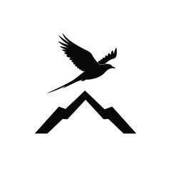 Silhouette of a bird flying above stylized mountain range in black and white for design