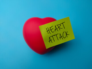 Closeup red heart shape with the word Heart Attack on a blue background