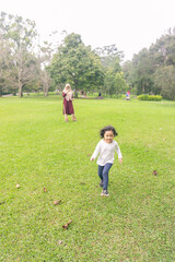Fototapeta premium Mother with little daugher is playing in an outdoor park