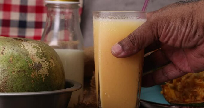 Southeast Asa wood apple bael fruit Limonia acidissima hard shell half inside flesh made juice drink ingredients 
