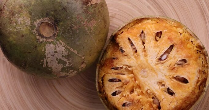 Southeast Asa wood apple bael fruit Limonia acidissima hard shell half inside flesh made juice drink ingredients 
