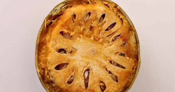 Southeast Asa wood apple bael fruit Limonia acidissima hard shell half inside flesh made juice drink ingredients 