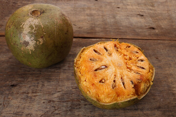 Southeast Asa wood apple bael fruit Limonia acidissima hard shell half inside flesh made juice drink ingredients