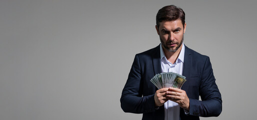 Successful business man counting money. Handsome middle age man holding bunch of 100 dollar banknotes. Guy holding money cash. Profit and financial success. Rich man with dollar cash.