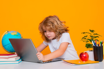 School child using laptop computer. School kid student learning, study language or literature at...