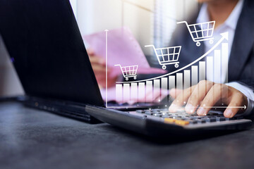 Businessman use calculator to calculate net profit from online sales in increasing trend and graph...