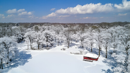 Aerial View of Snowy Winter Landscape with Red Cabin