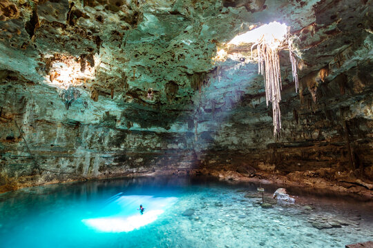 Man swimming in a cenote, Yucatan, Mexico
