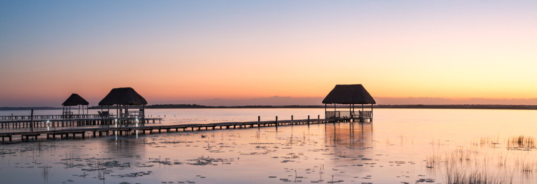 Panoramic of pier and hut at sunset, Laguna Bacalar, Mexico