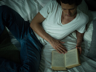 An adult man reading a book