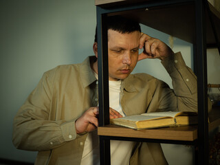 An adult man reading a book