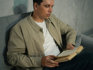 An adult man reading a book