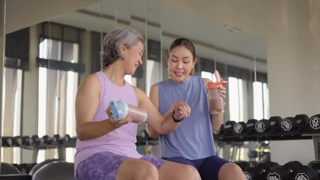 Young adult active middle age old female drink whey energy shake bottle diet food after gym workout. Self Love health care older aged woman asia elder people happy relax sport protect aging life.