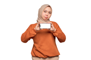 Bored young Asian woman in orange shirt showing mobile phone blank screen recommending App isolated on transparent background