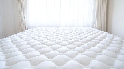 Soft white quilted mattress topper bedroom interior closeup comfort sleep home decor