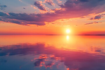 A stunning sunset over a tranquil lake with vibrant orange and pink hues reflecting on the water's surface