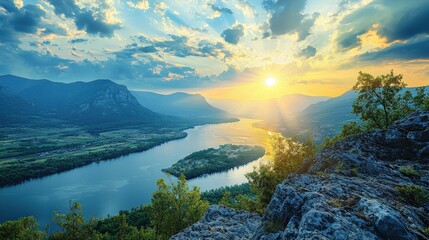 Dramatic panoramic landscape of the mountains, river, cloudy sky with sun flare in the sky