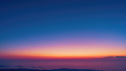 Colorful and cloudless sky during twilight before sunrise, mountain top view