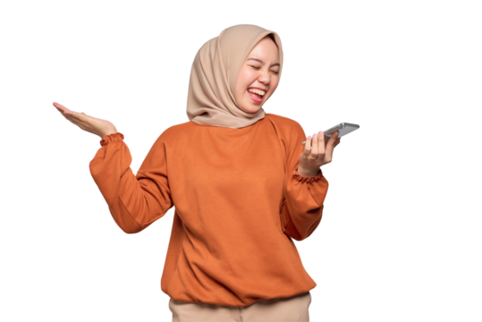 Cheerful young Asian woman in orange shirt using the voice assistant on mobile phone isolated on transparent background