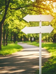 Directional signpost in sunny park, two arrows pointing different ways, decision making concept, low angle view, outdoors
