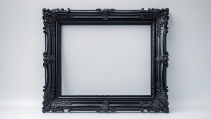 Classic black wooden frame featuring ornate patterns against a white backdrop