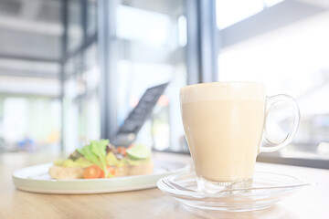 cappuccino, coffee in a clear glass cup in a cafe, soft color background food and drink, hot drink