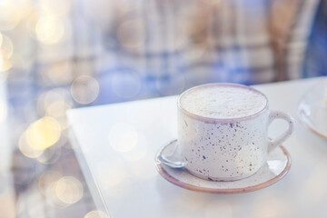 a cup of coffee on a summer morning, sideways sunlight and rays, blurred soft color background, bokeh