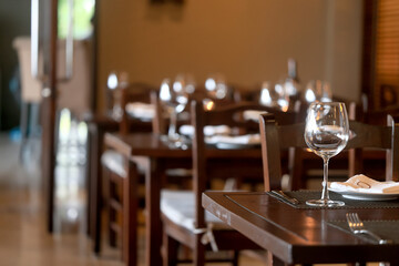 table setting in the restaurant, glasses and cutlery, a clean new table in the restaurant is waiting for guests, a free table