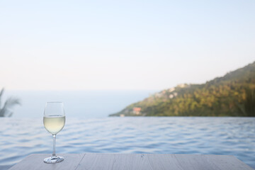 glass of cold white wine on the summer seashore by the water, relaxing by the water, a gentle background of soft color