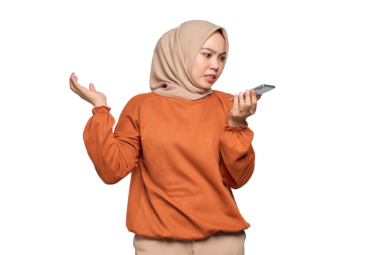 Confused young Asian woman in orange shirt using the voice assistant on mobile phone isolated on transparent background