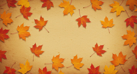 Autumn maple leaves arranged on a textured beige background with copy space
