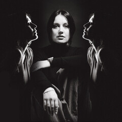 Portrait of a woman with dark hair, done in low key style.