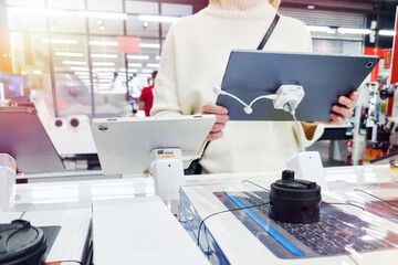 Woman with digital tablet in store
