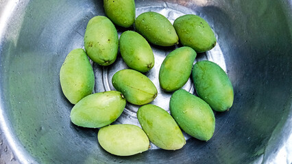 Fresh Green Mangoes in Gleaming Metal Bowl