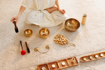 Mindful sound healing setup with meditation bowls, candles, and spiritual instruments.