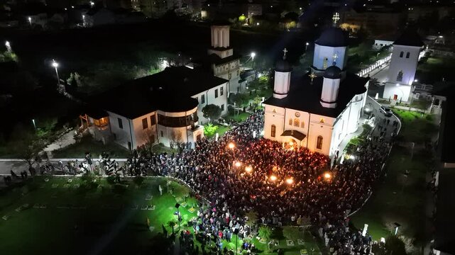 Aerial view of a wedding ceremony outdoors of Archdiocese of Ramnicu at night, Romania