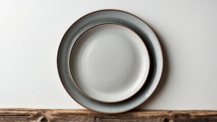Table display with a blank white plate on weathered wood.