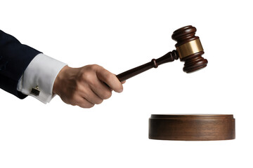 Close-up of a man's hand in a suit holding a judge's gavel about to strike a wooden block against...
