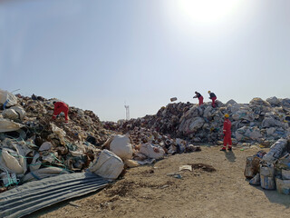 A collection point for sorting, recycling and disposal of industrial waste. Waste Management Center. Workers separate metal waste from mixed waste.