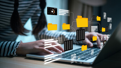 Conceptual image representing a digital data management system, network, or cloud computing service, with holographic documents and a folder displayed above a hand.