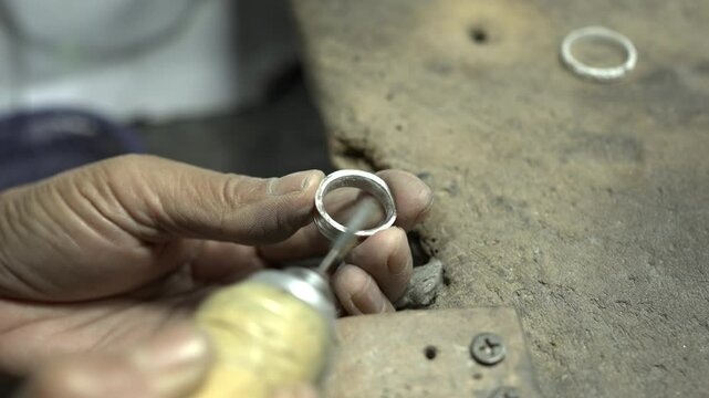 Jeweler at work in jewelry. Desktop for craft jewelry making with professional tools. Close up view of tools. Thailand.	