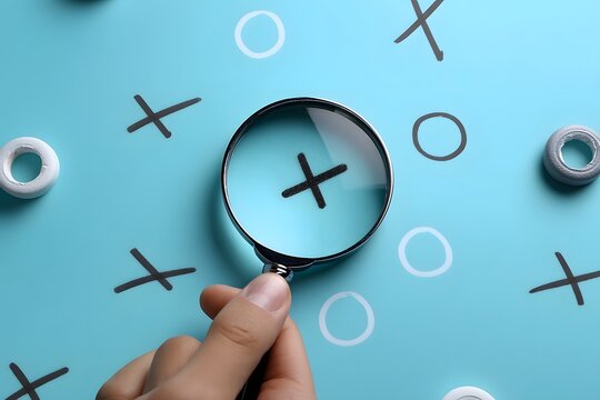 Magnifying Glass Focuses on a Cross Detail Among Xs and Os on a Blue Background