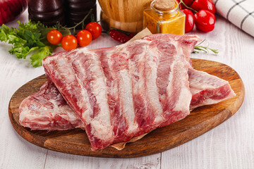 Raw pork ribs over board