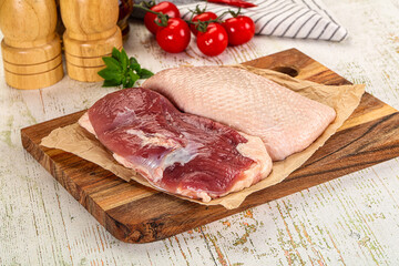Raw duck breast over board