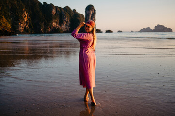 Young Blonde Woman in Pink Dress at Ao Nang Beach During Golden Hour